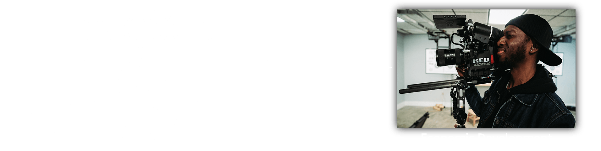 A man is standing in front of a camera in a room.