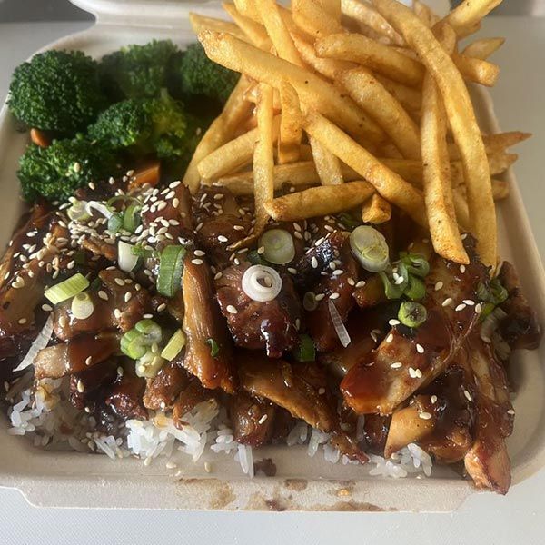 A styrofoam container filled with rice , broccoli and french fries.