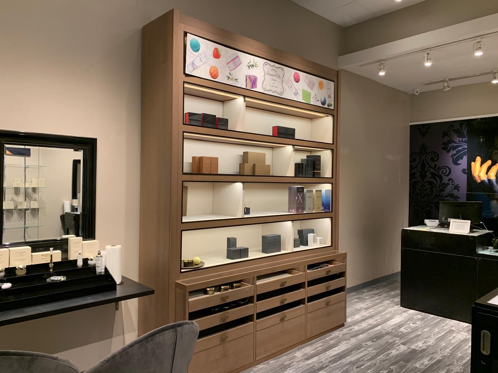 Wooden retail display showcasing products under warm lighting.