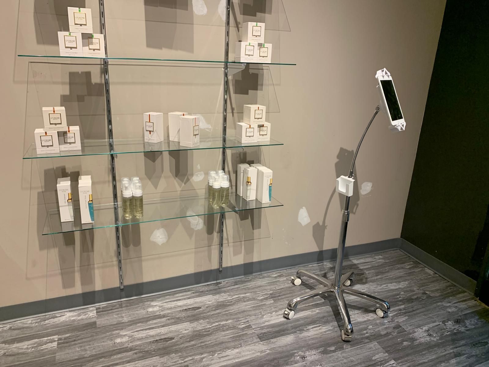 Shelves with products and a phone stand in a retail space.