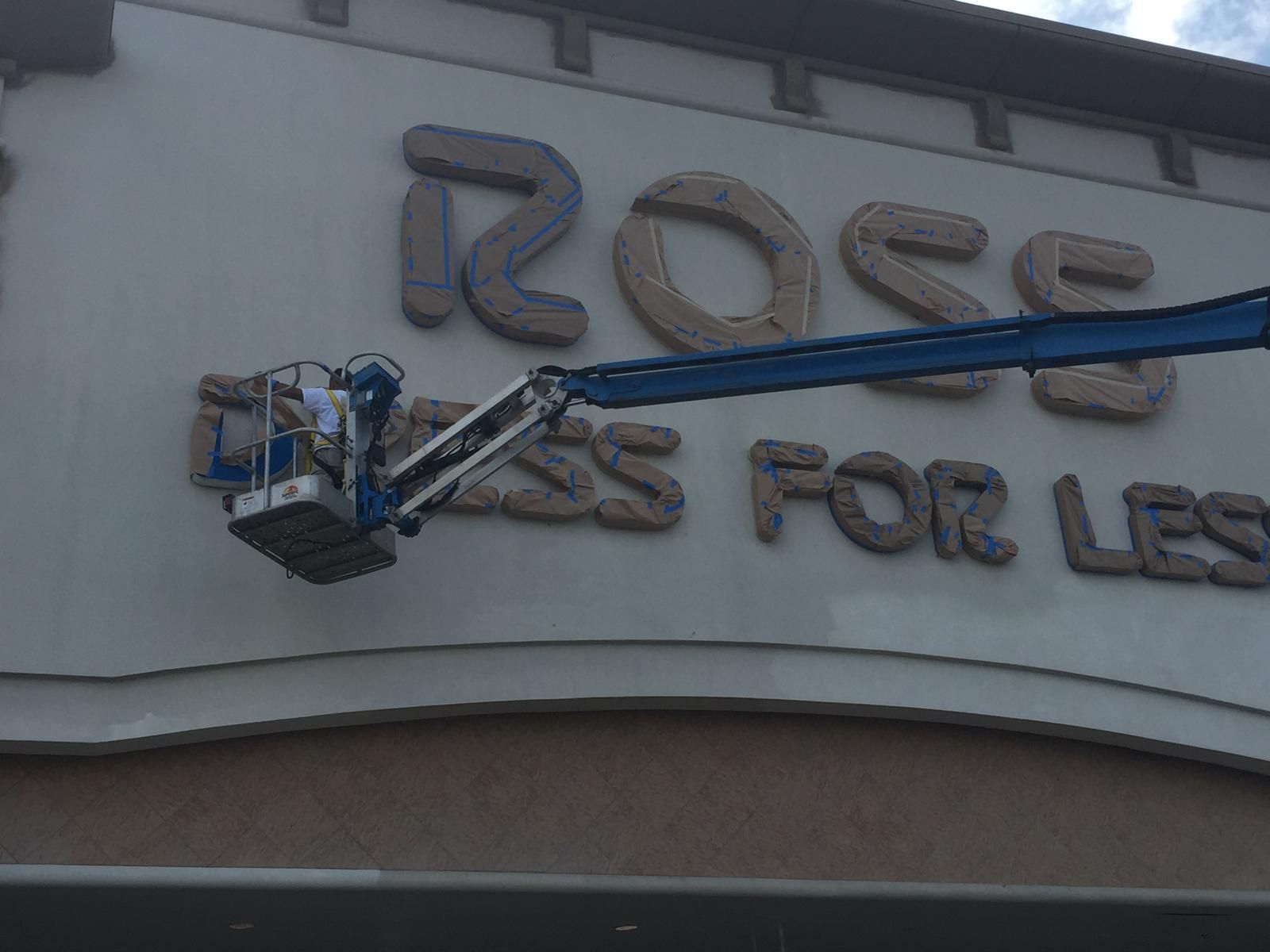 Man in a lift painting the 