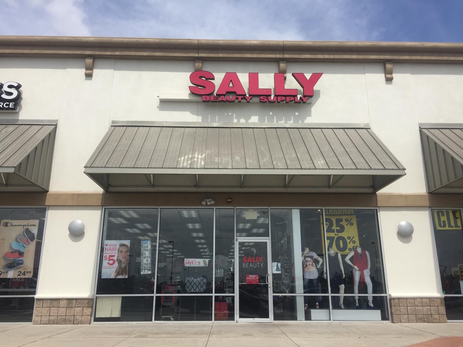 Sally Beauty Supply store front with red sign and display windows.