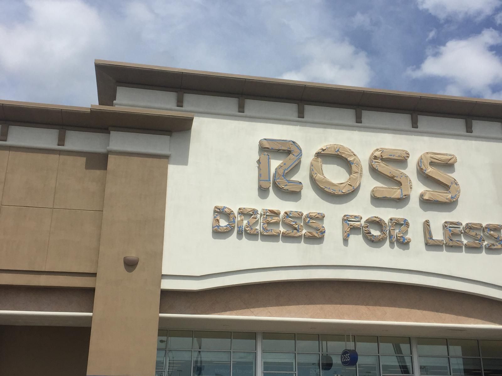 Ross Dress for Less store sign with tan and white exterior, under a cloudy sky.