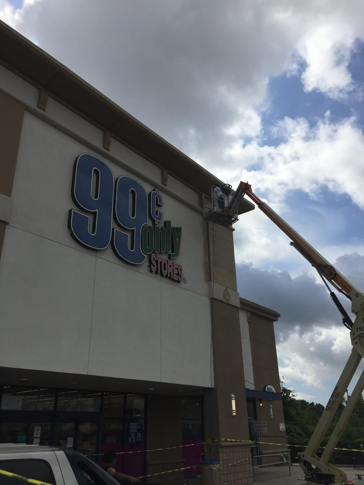 A worker on a lift repairs the 
