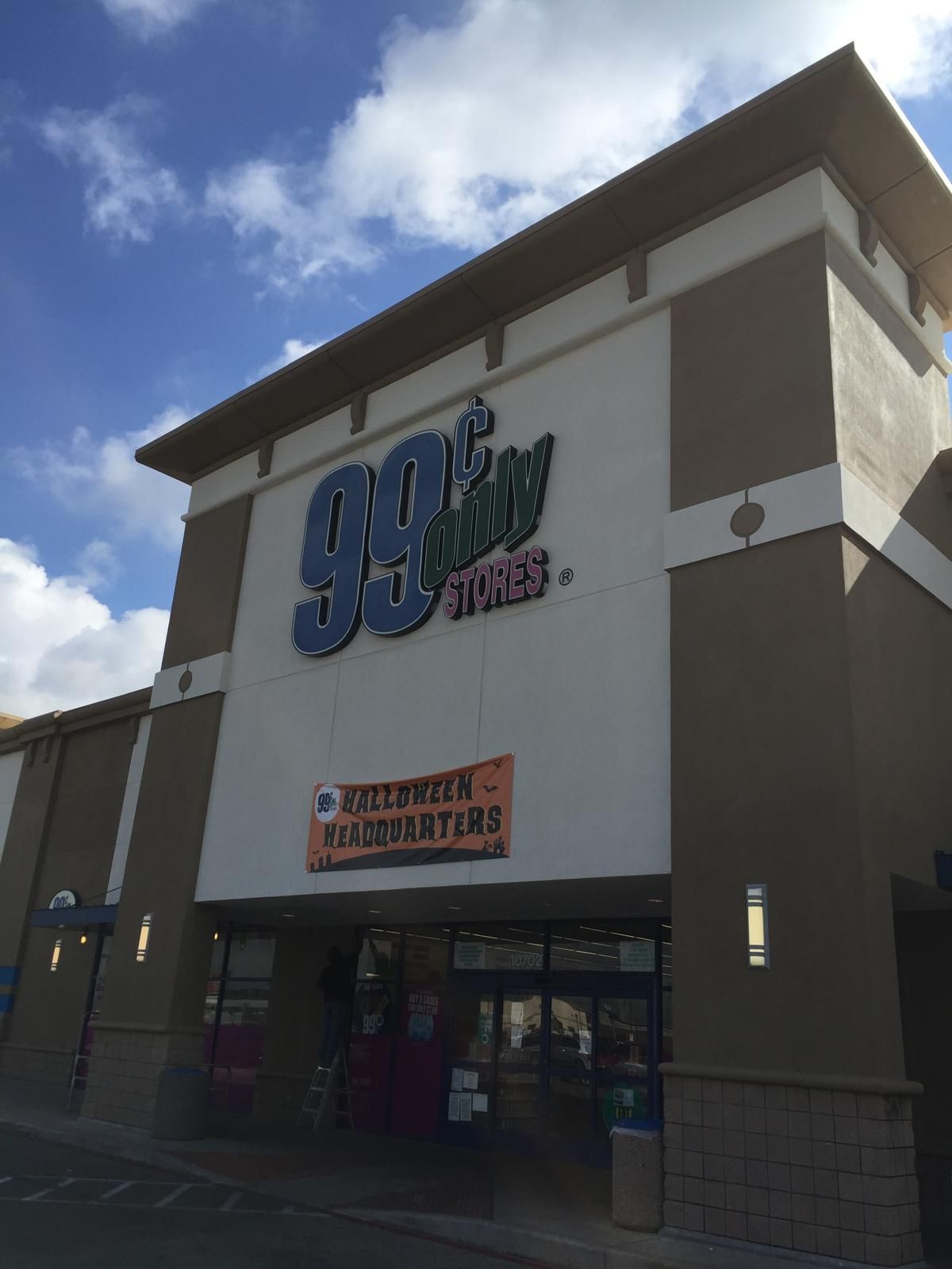 99 Cents Only store exterior under a partly cloudy sky. A 
