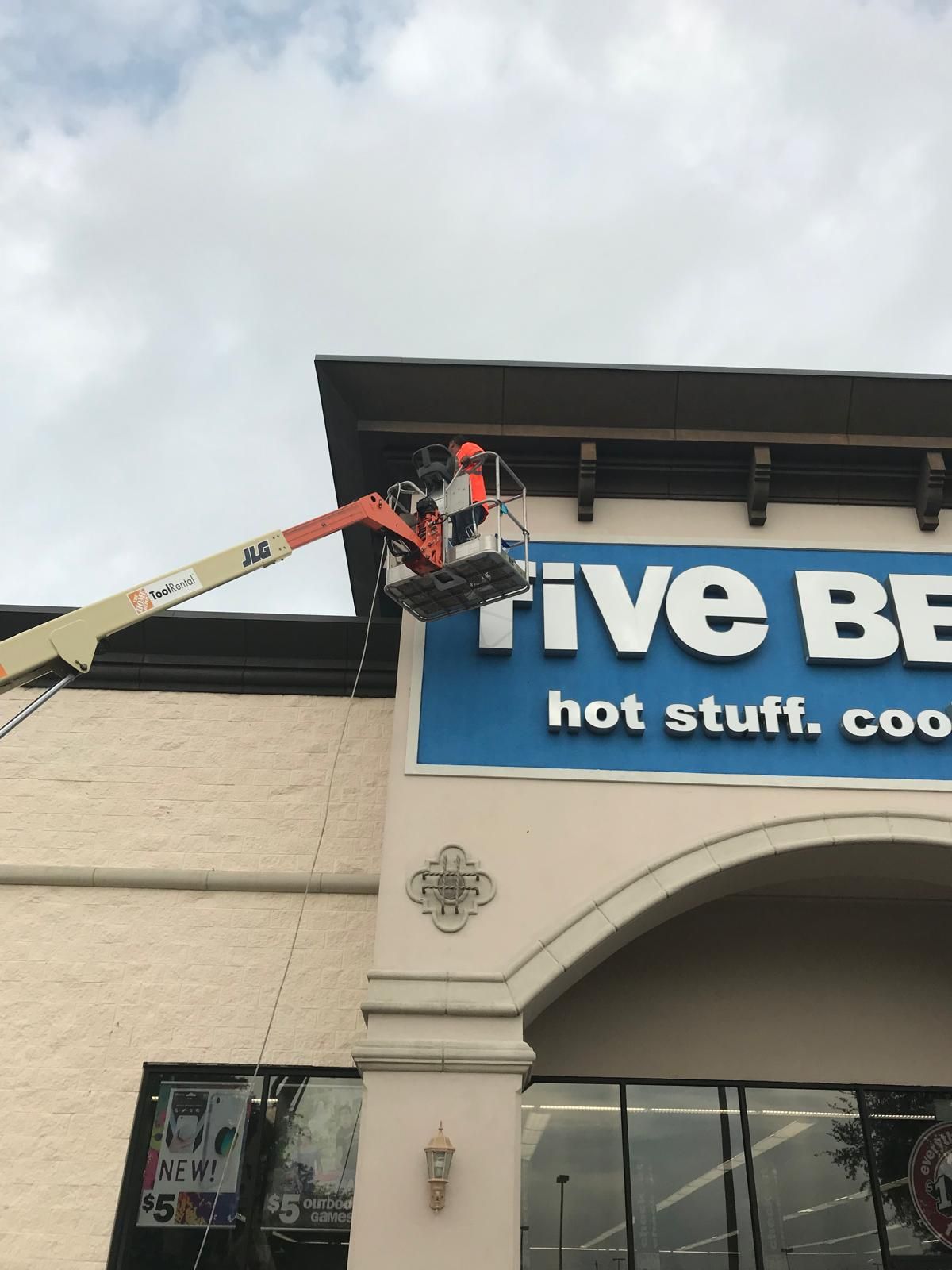 A worker in a cherry picker repairs the 