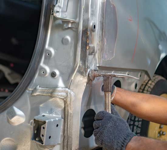 Mechanic Repairs the Car Body — Kenner, LA — Rivertown Collision Center