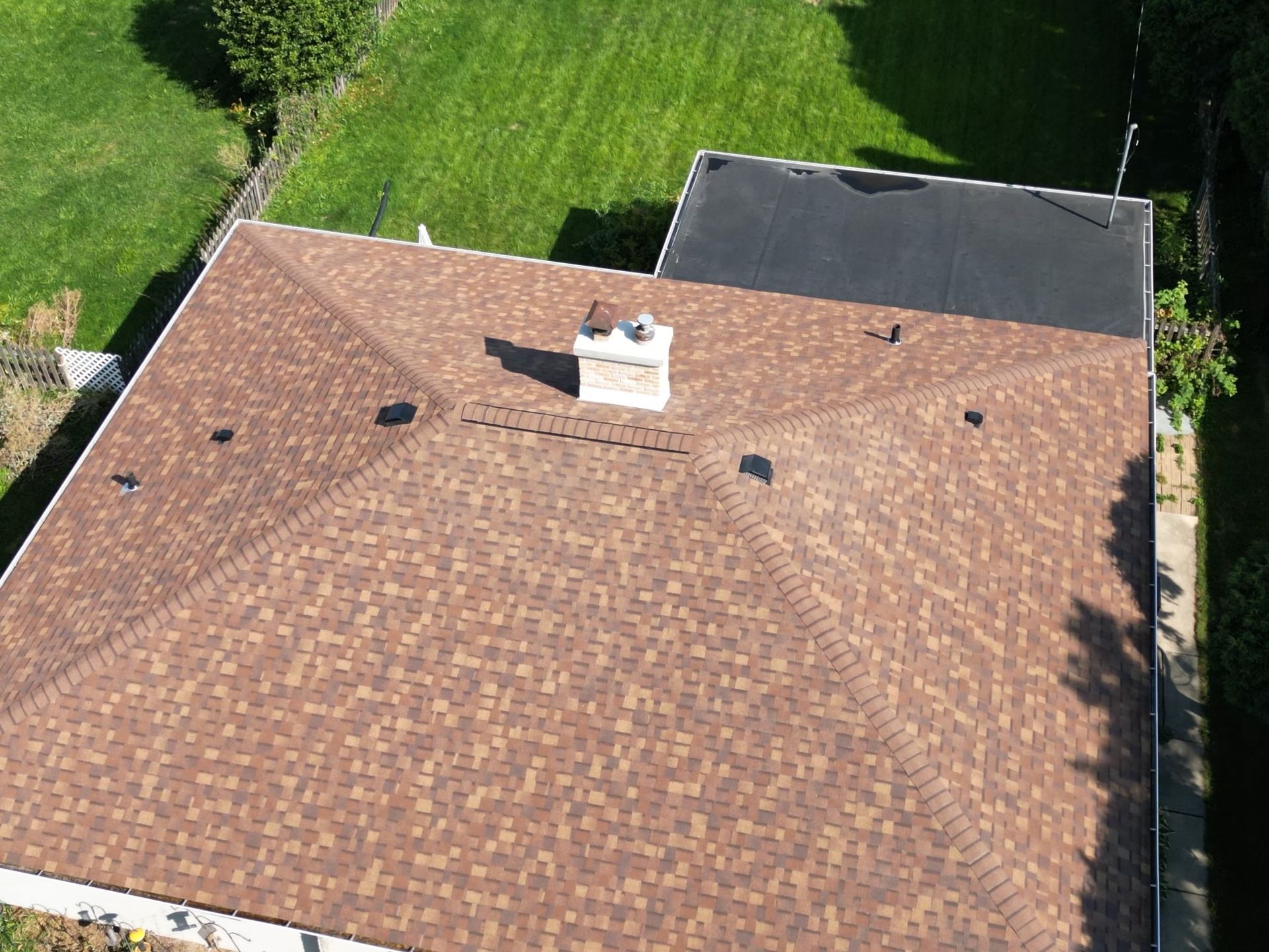 An aerial view of a house with a roof and a chimney.
