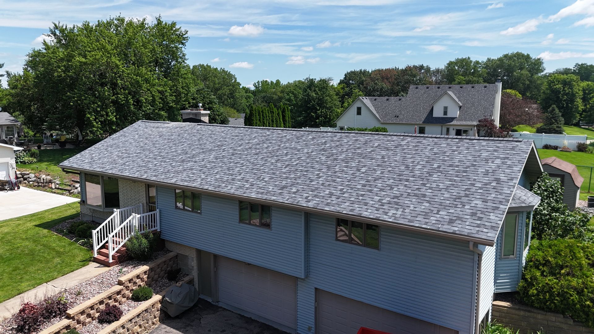 An aerial view of a house with a gray roof.