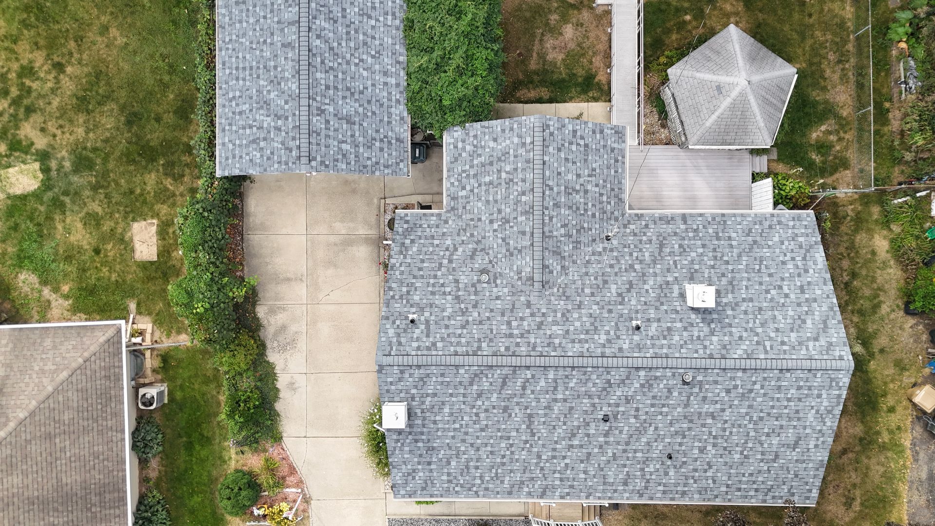 An aerial view of a house with a roof and a gazebo.