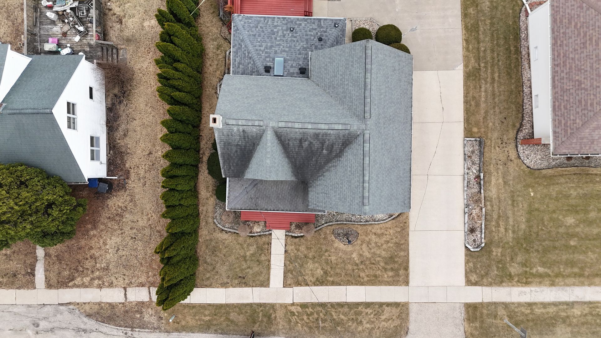 An aerial view of a house in a residential neighborhood.