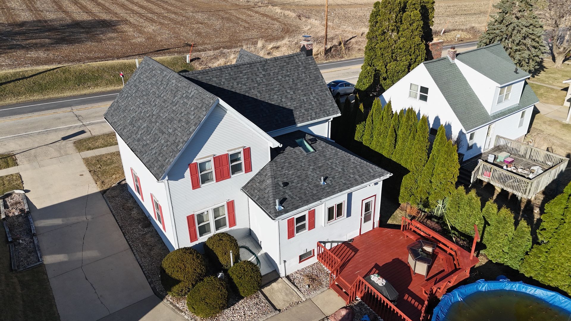 An aerial view of a house with a pool in the backyard.