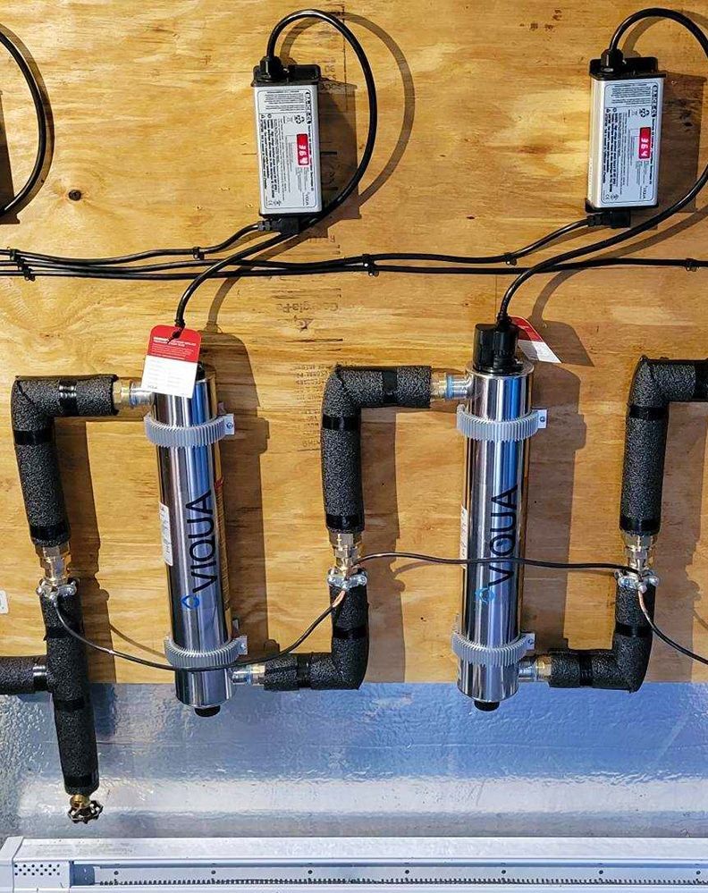 A wooden wall with a bunch of wires connected to it