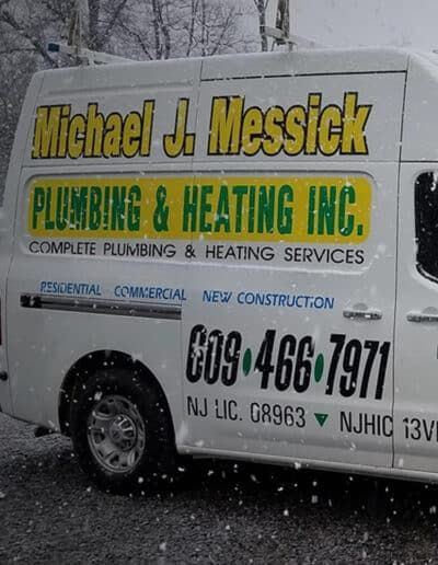 A white van that says michael j messick plumbing & heating inc.