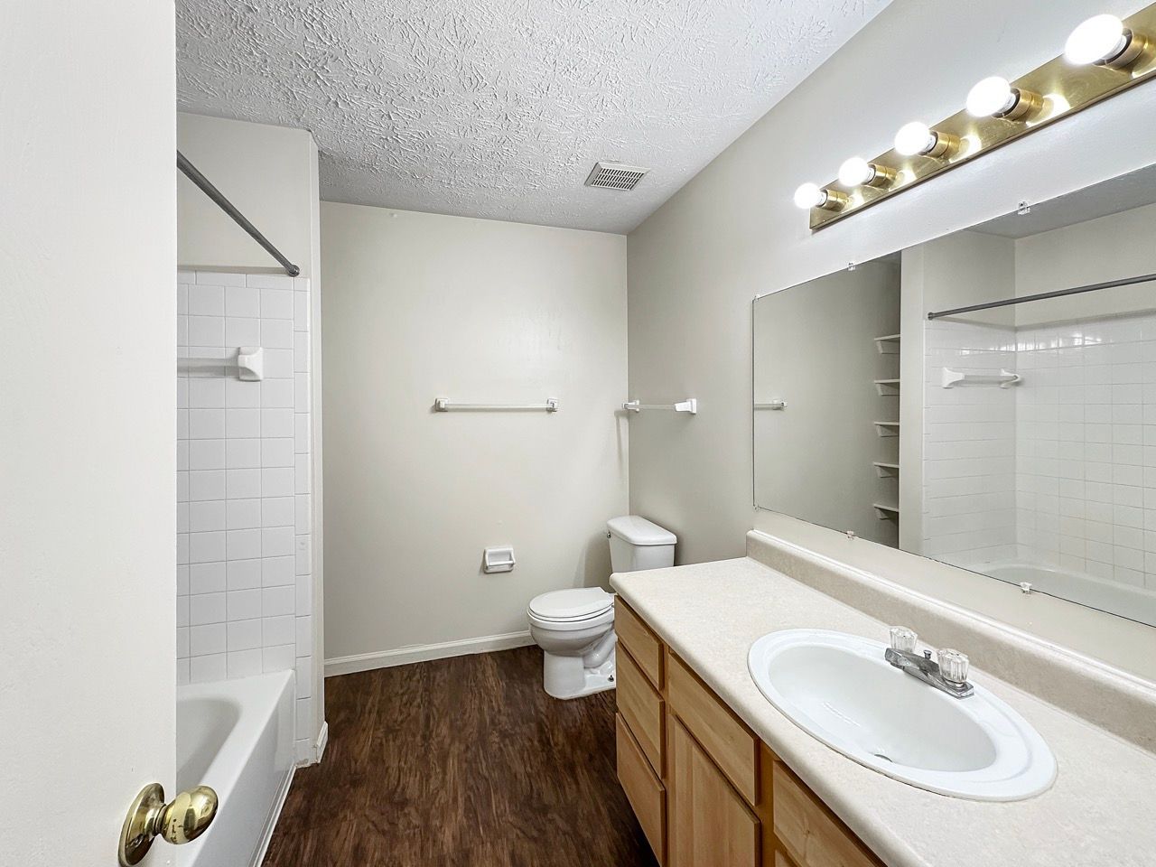 A bathroom with a toilet , sink , and mirror