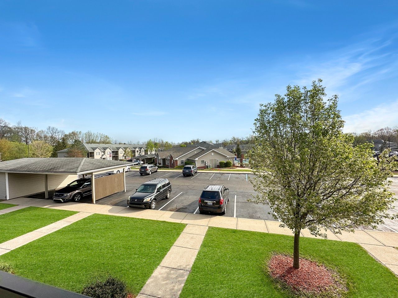 A view of a parking lot with cars parked in it.