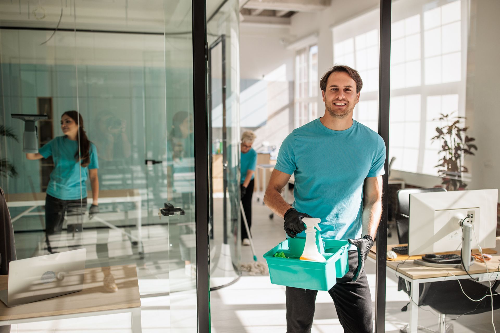 A cleaning team is using equipment to maintain cleanliness in a professional work environment.