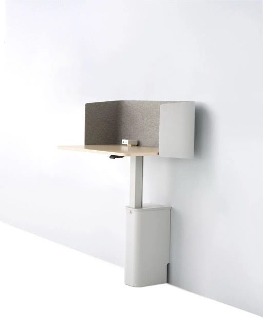 Compact green workstation with a black monitor, white desk, and central support on a white background