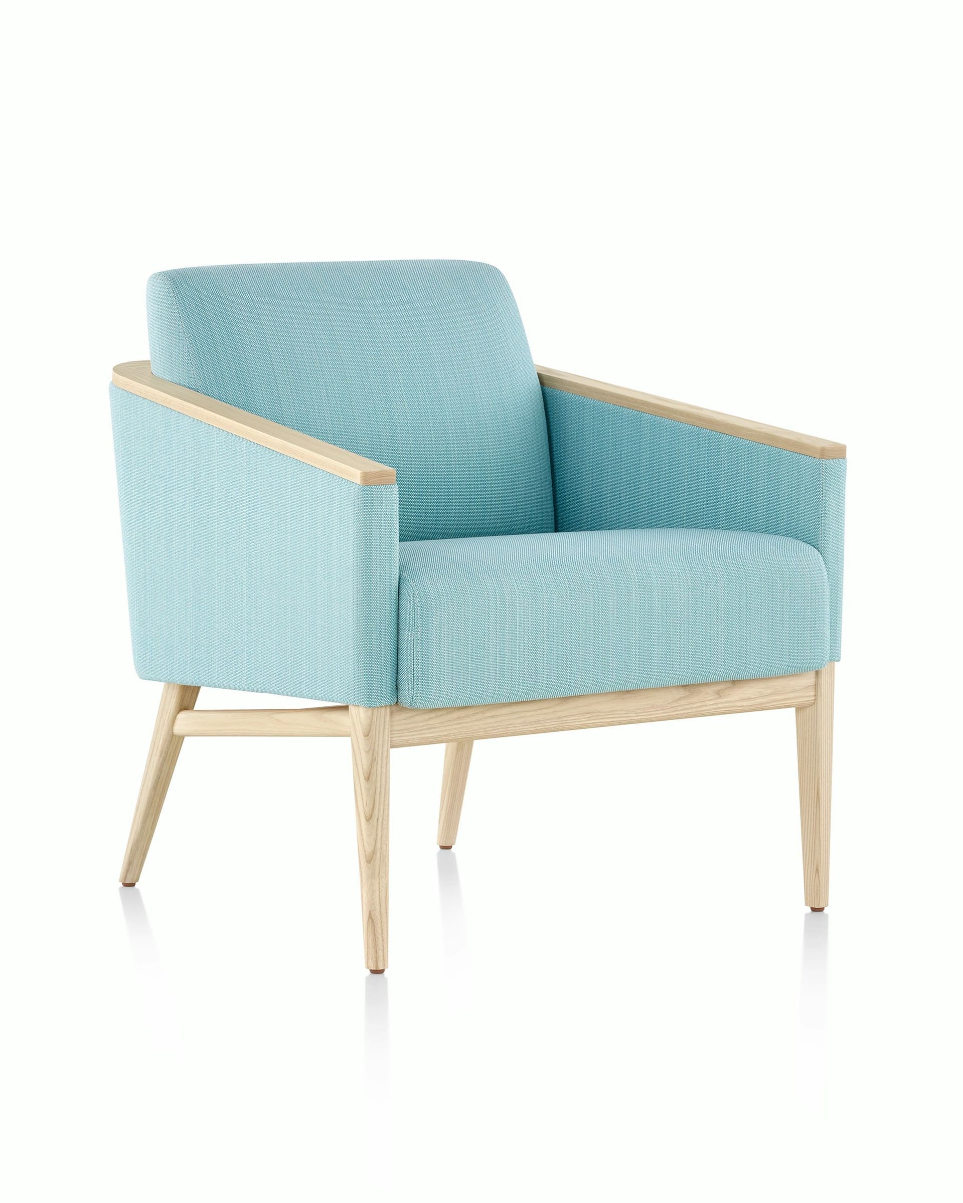 Light blue upholstered armchair with wooden legs on a white background