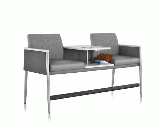Modern gray upholstered bench with two seats and a small white table between them