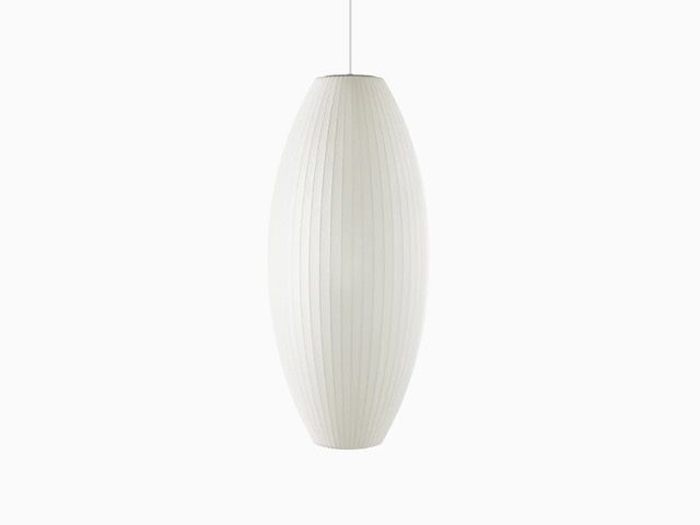 Three white pendant lamps with textured shades hanging against a plain white background