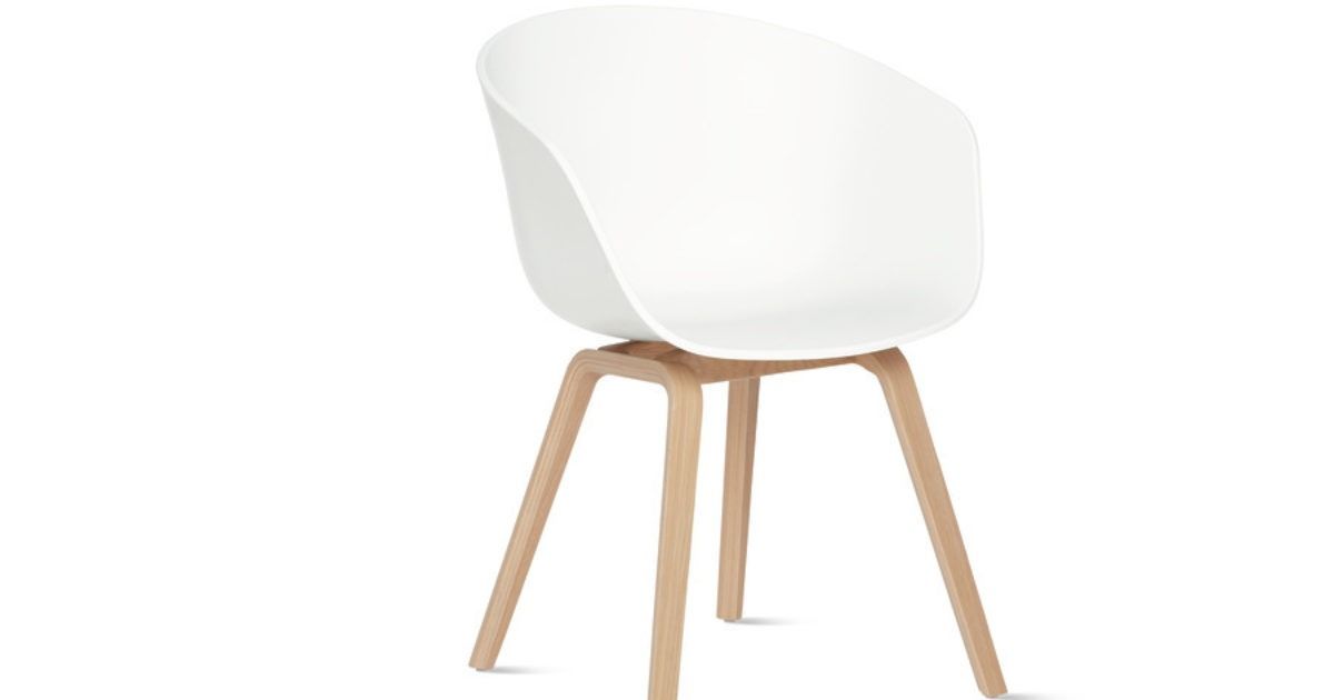 Black chair with white metal legs on a white background