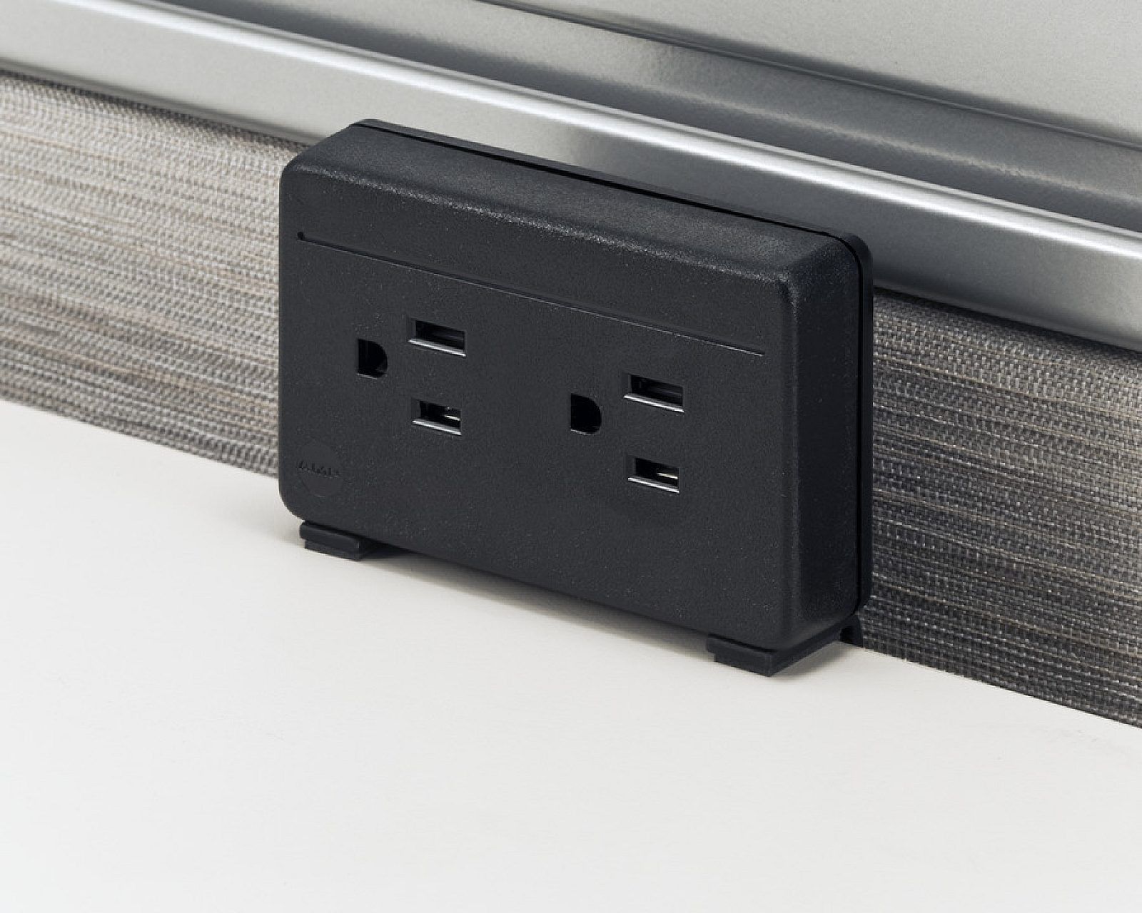Wall-mounted gray electrical panel with two switches and two outlets on a white background