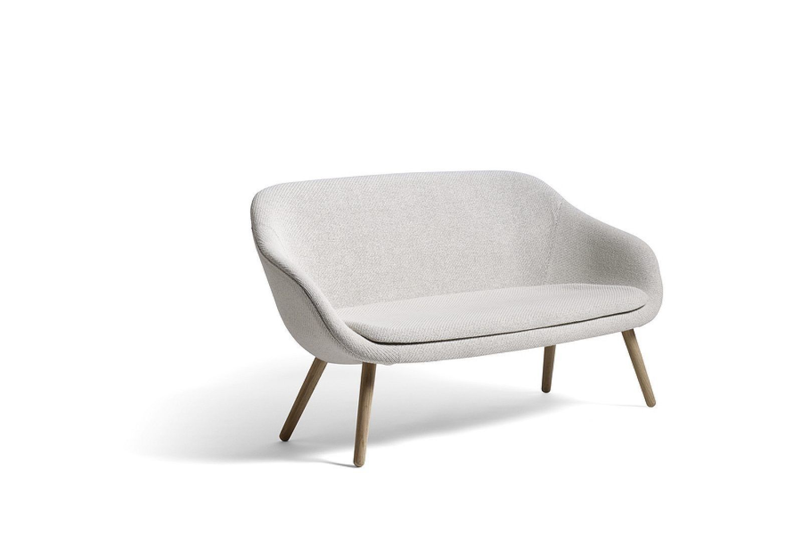 Light gray upholstered lounge chair with wooden legs on a white background