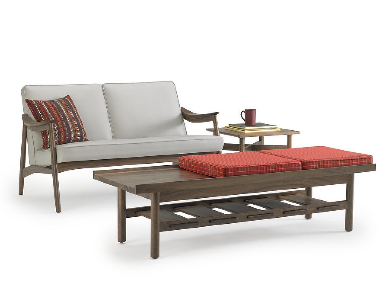 Outdoor patio seating with gray sofa, wooden coffee table, and red cushions