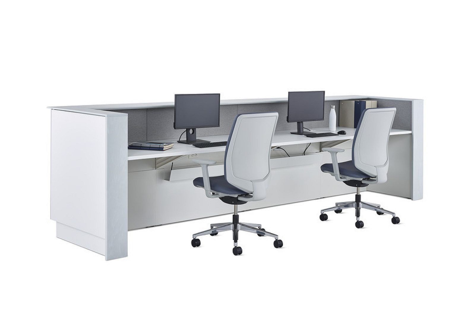 Modern office cubicles with two desks, computer monitors, and white swivel chairs