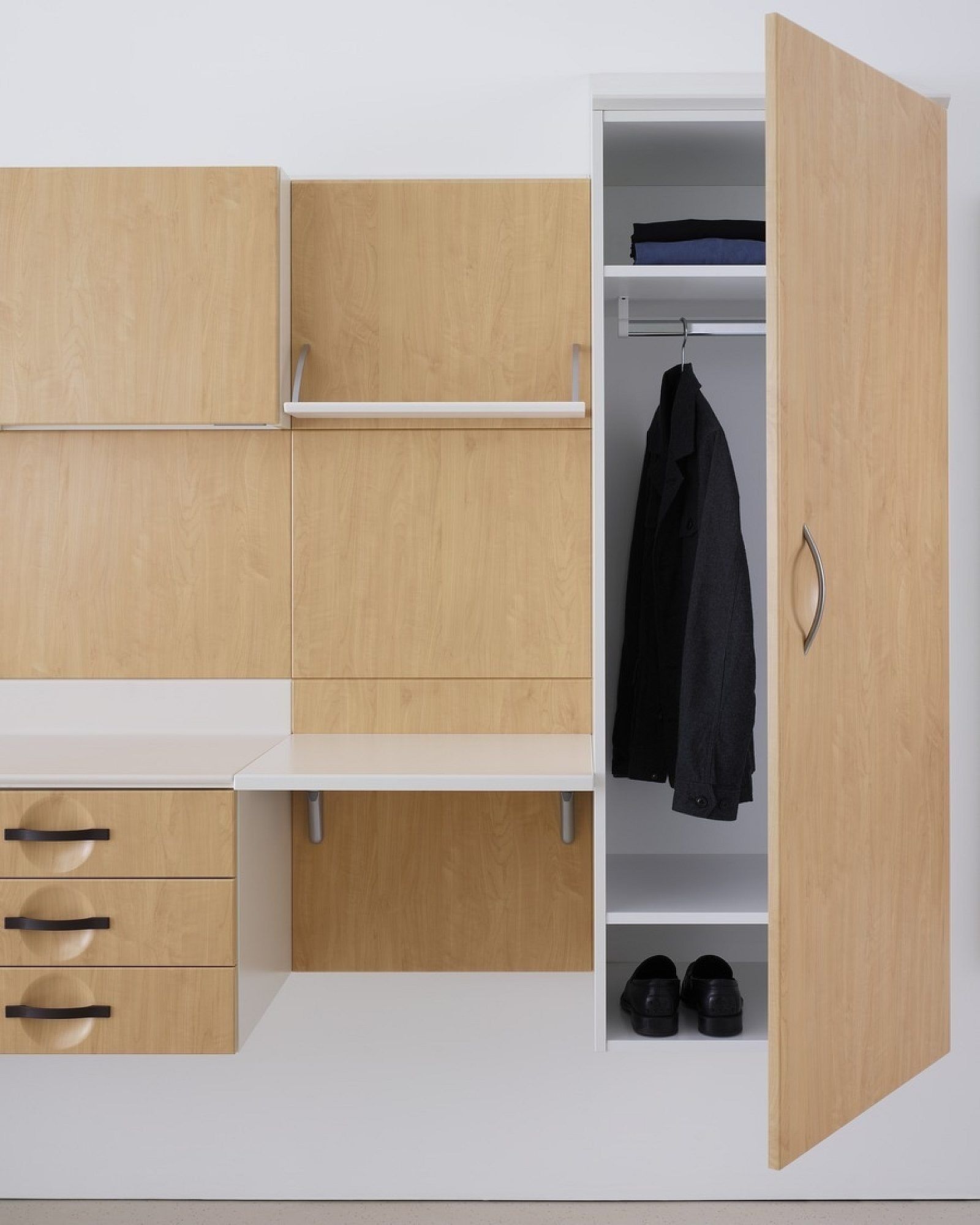 Modern wooden wardrobe unit with shelves, drawers, hanging clothes, and an open door