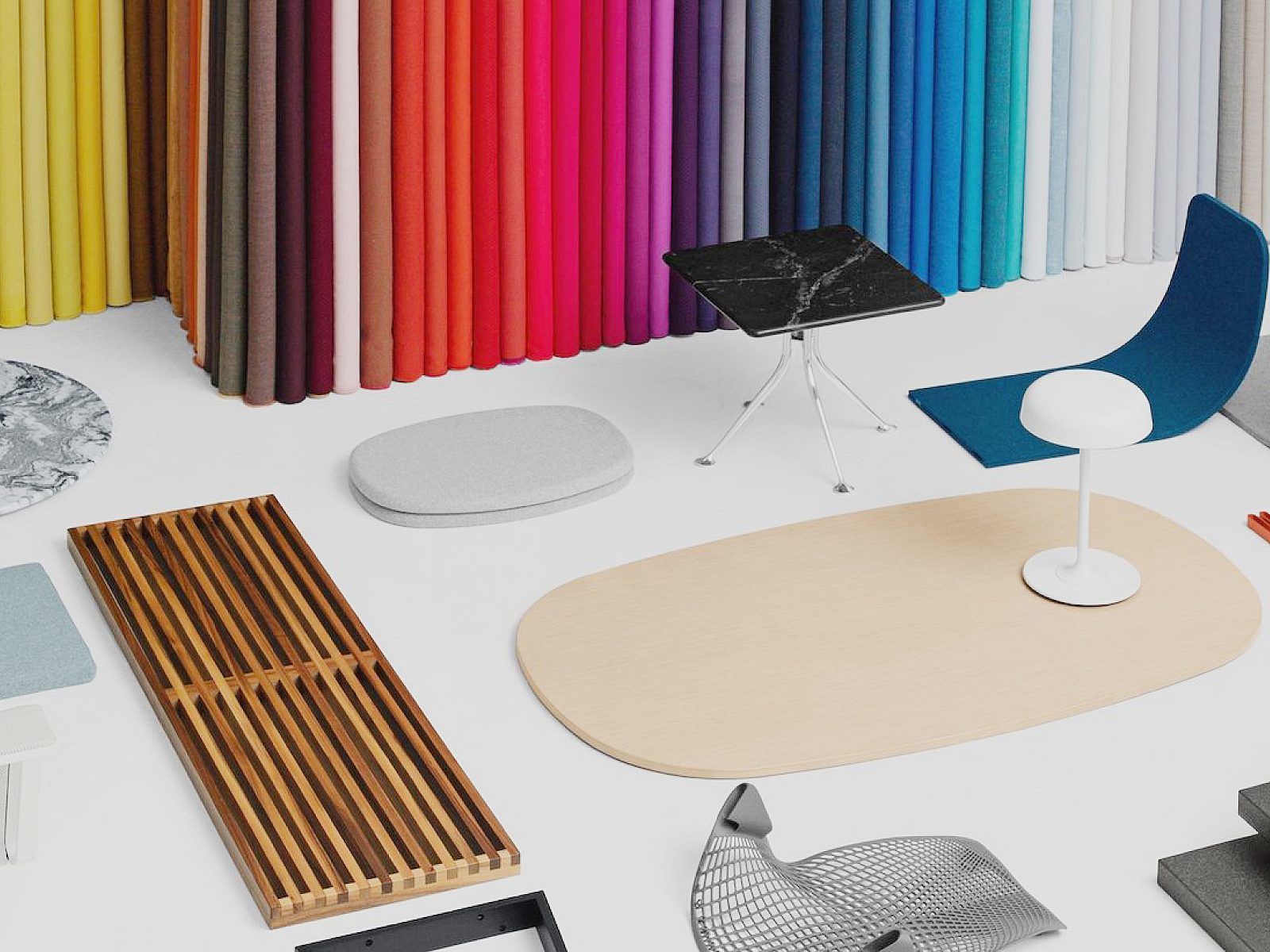 Modern chairs and tables in a colorful design showroom with multicolored curtains and rugs