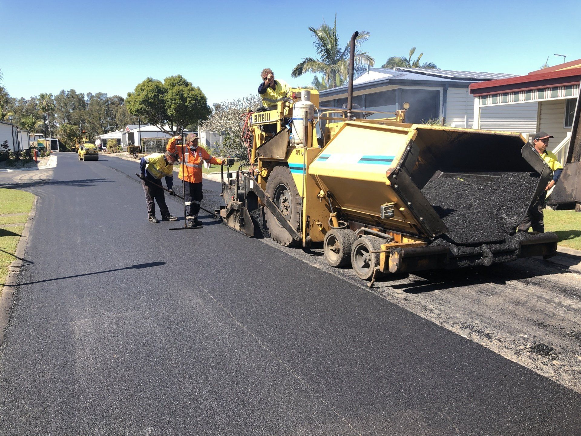 A group of construction workers are working on a road.