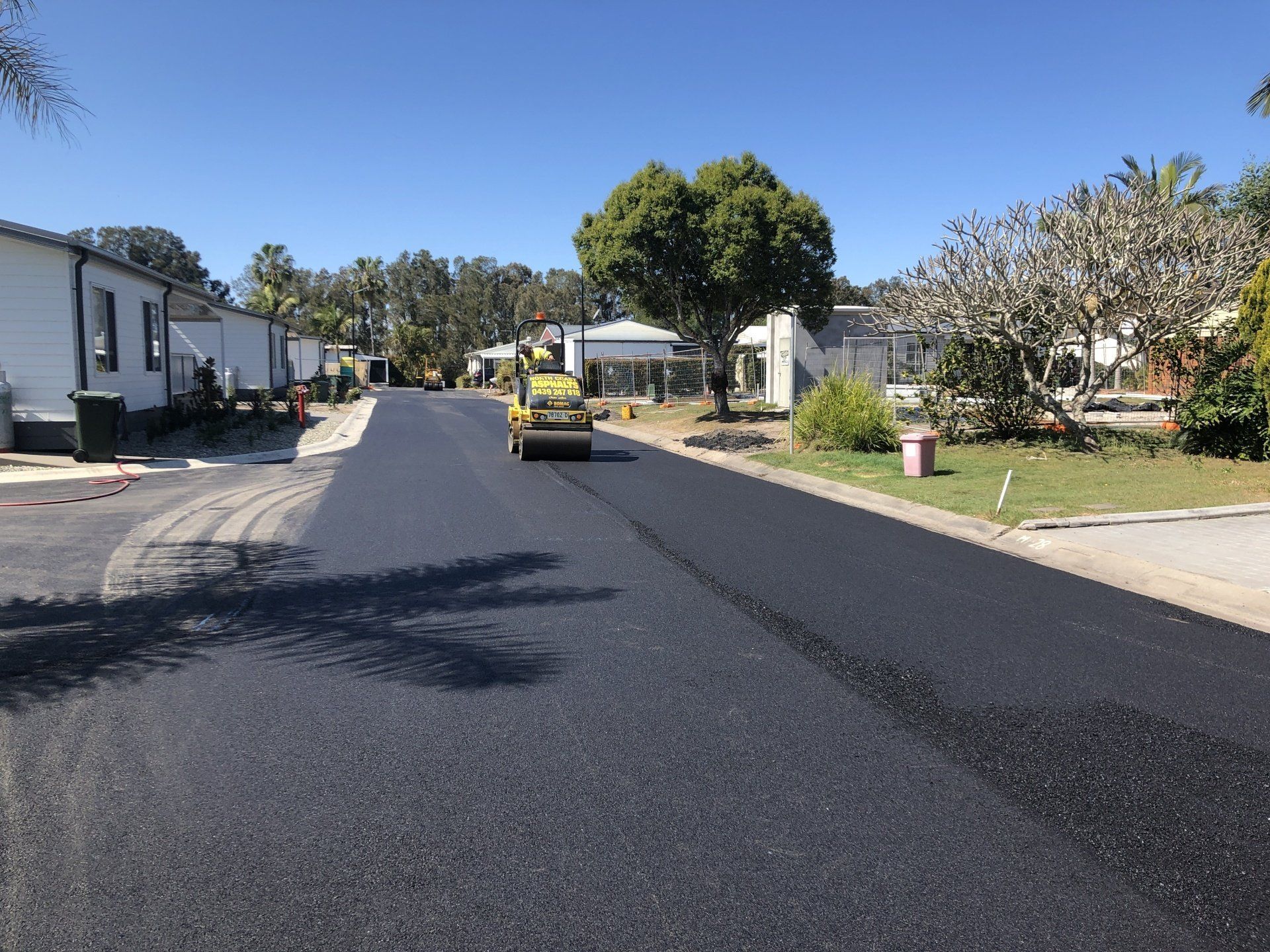 A road is being paved in a residential area.