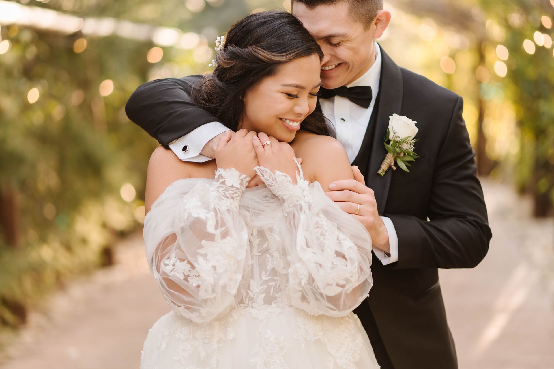 A bride and groom are posing for a picture on their wedding day.