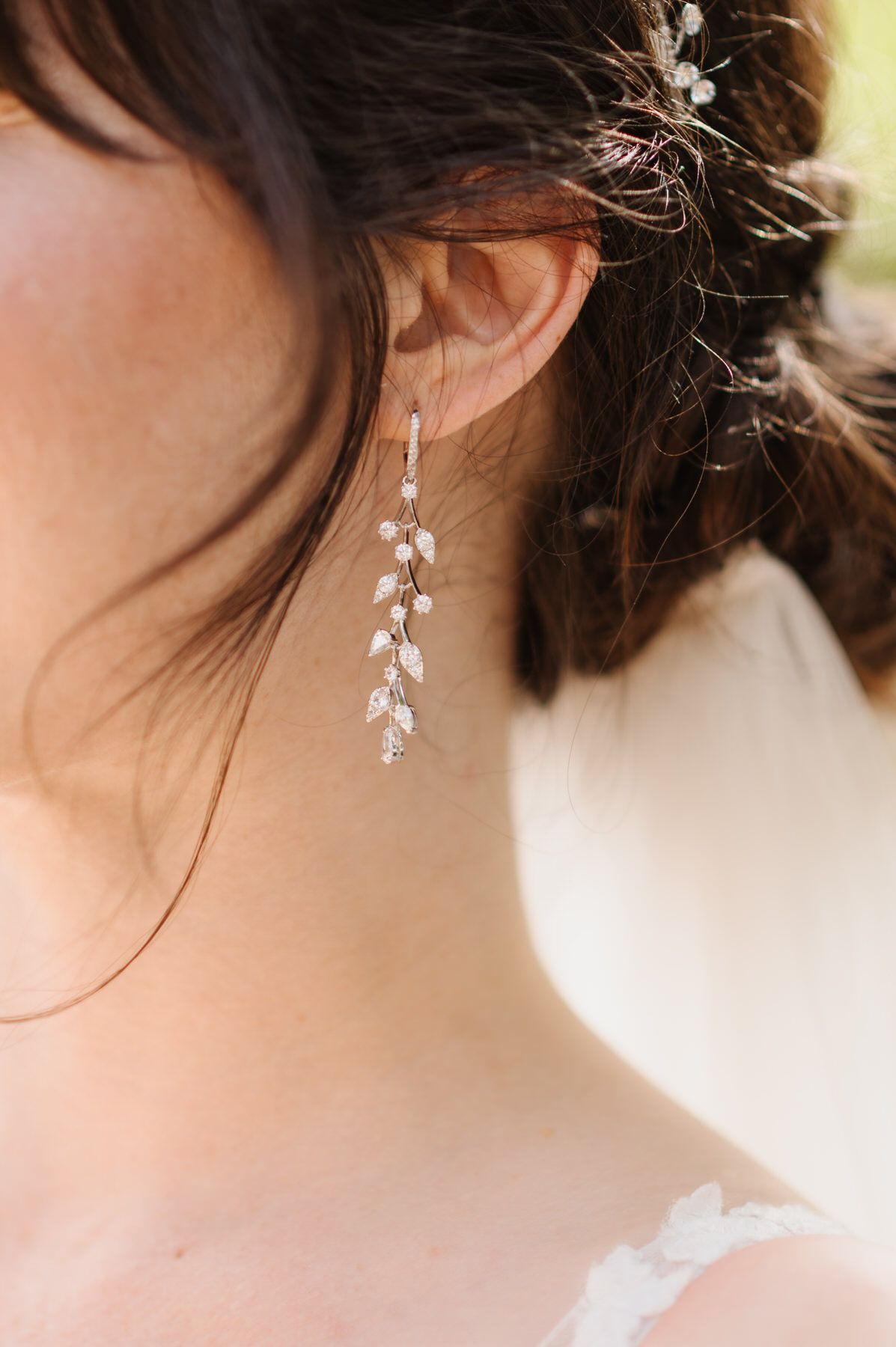 A close up of a woman wearing a pair of earrings.