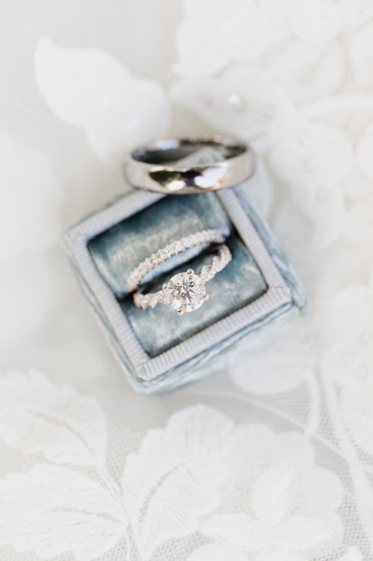 A couple of wedding rings sitting on top of each other in a box. Sherman Garden wedding photos