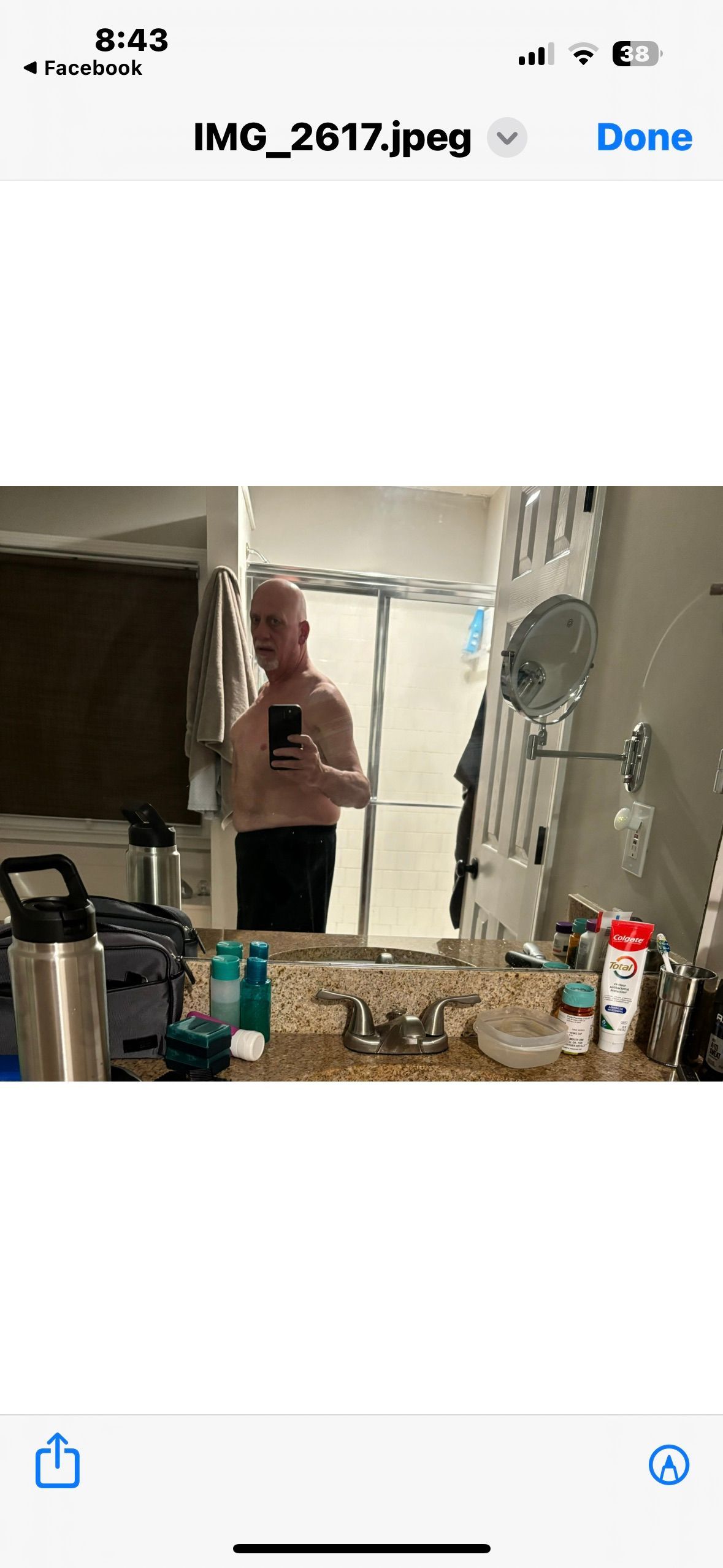 A man is taking a picture of himself in a bathroom mirror.