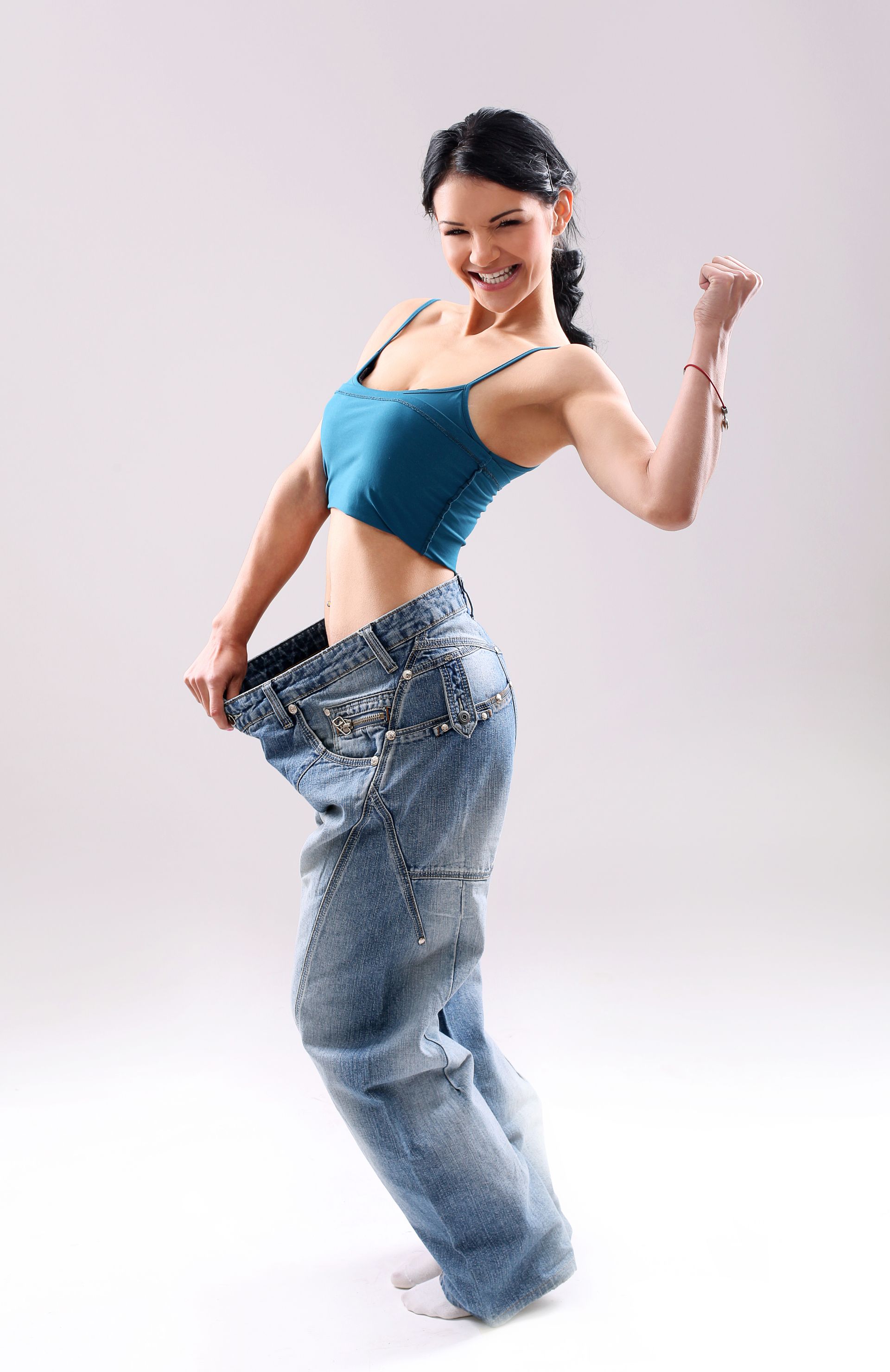 A woman is wearing a pair of very large jeans.