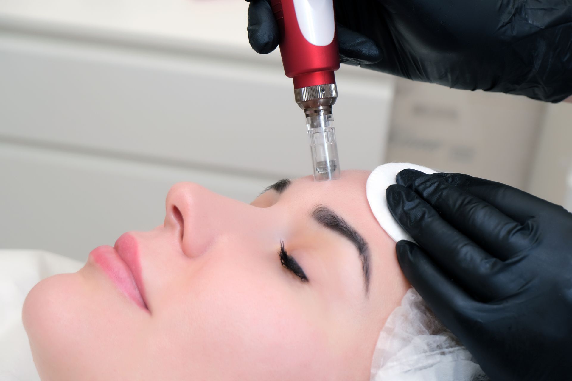 A woman is getting a facial treatment at a beauty salon.