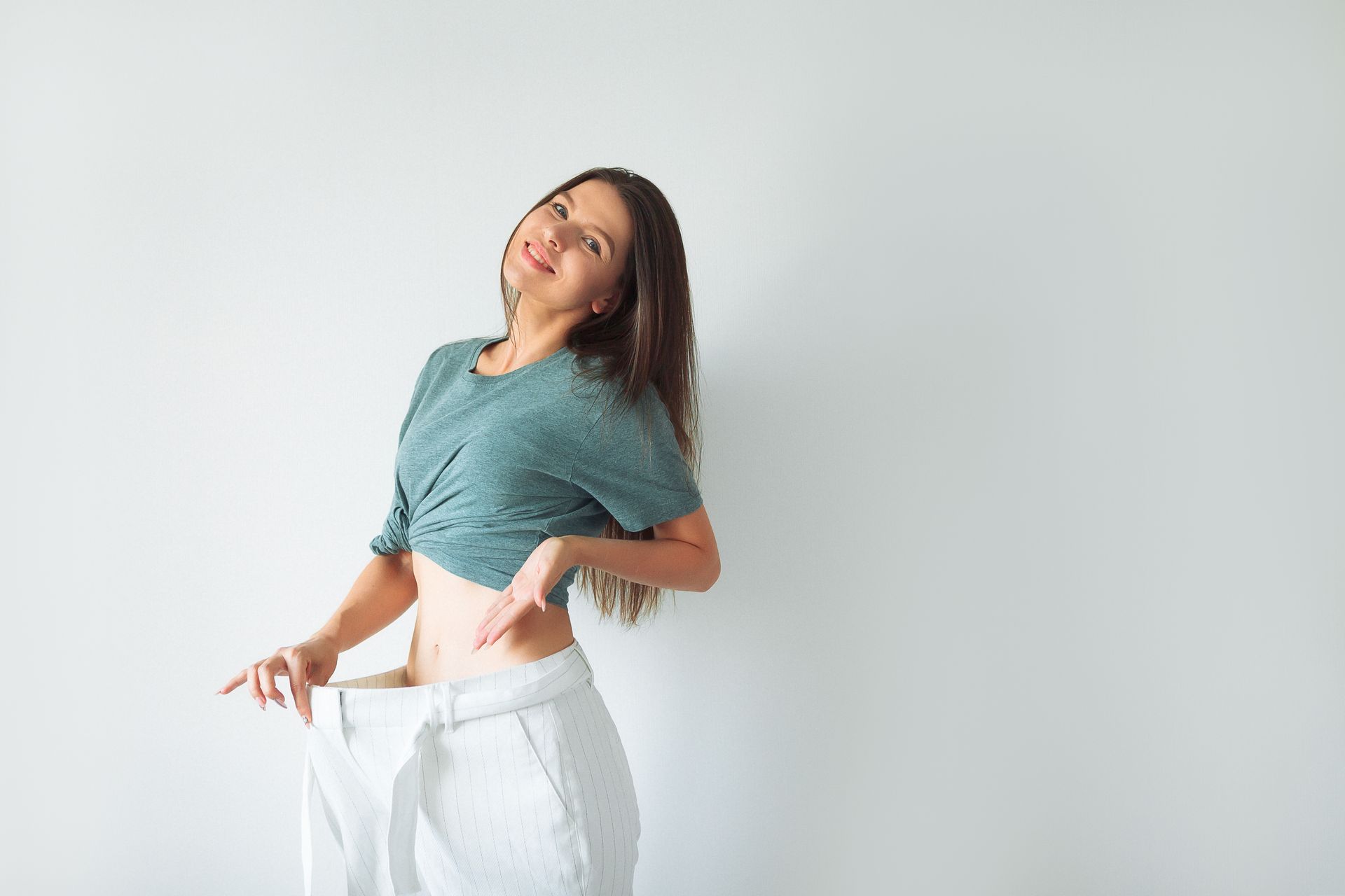 A woman is wearing a pair of very large pants.