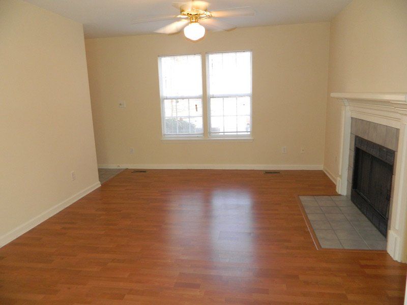 The living room with hardwood floors and a fireplace