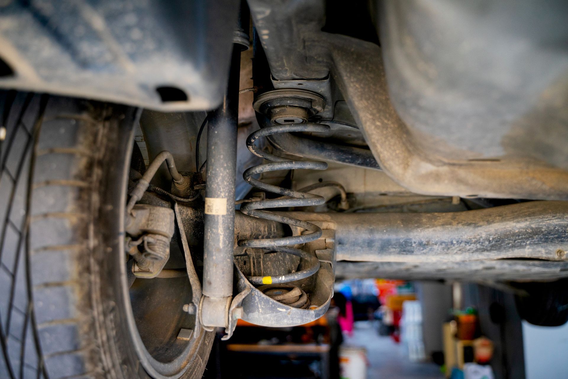 A close up of the underside of a car with a shock absorber.