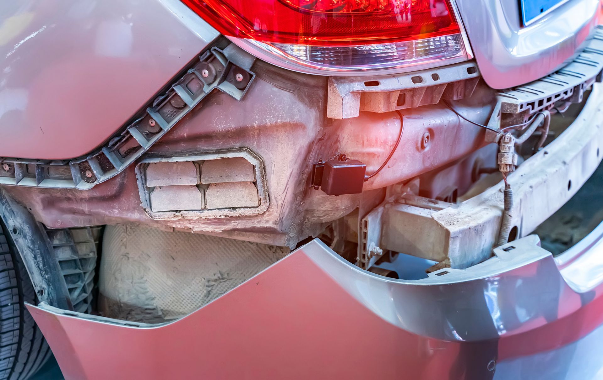 A close up of a car with a damaged bumper.