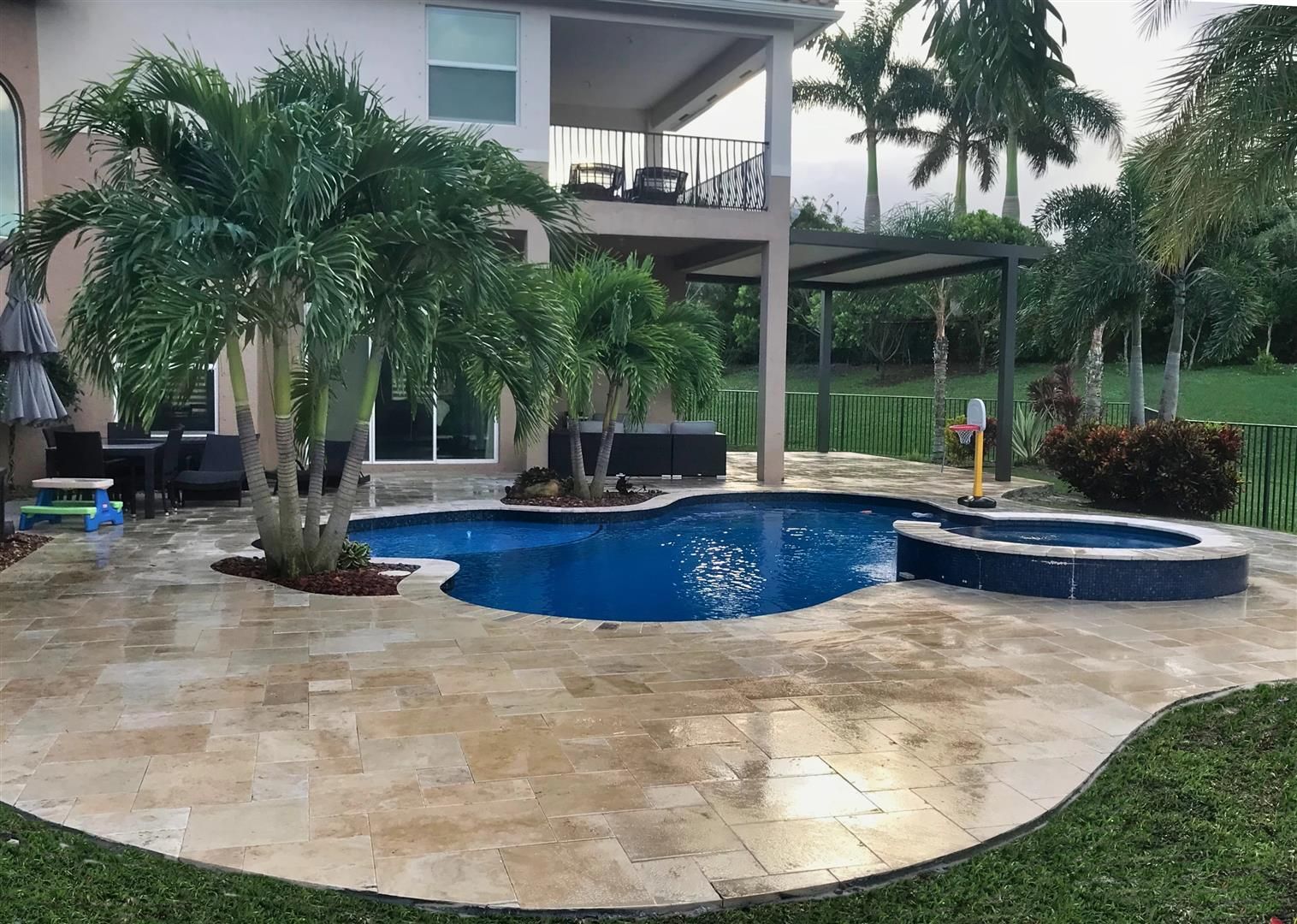 A large swimming pool in the backyard of a house