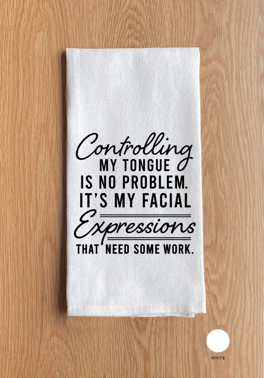 White towel on wood background with humorous black text about controlling tongue and facial expressions.