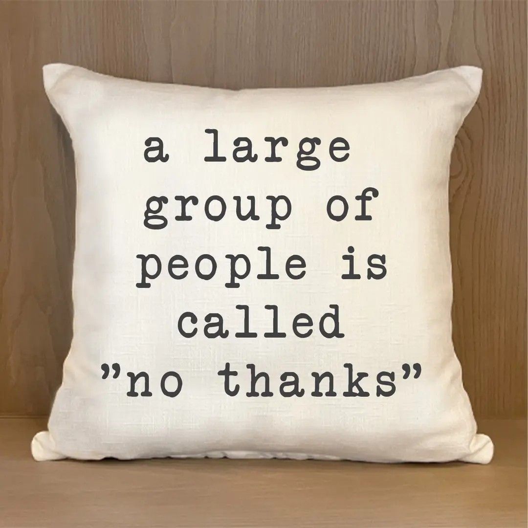 White pillow with typed text: “a large group of people is called ‘no thanks’”