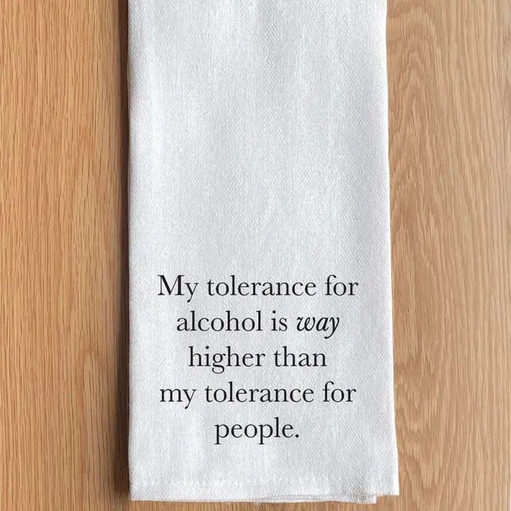 White napkin on wood background with text: “My tolerance for alcohol is way higher than my tolerance for people.”
