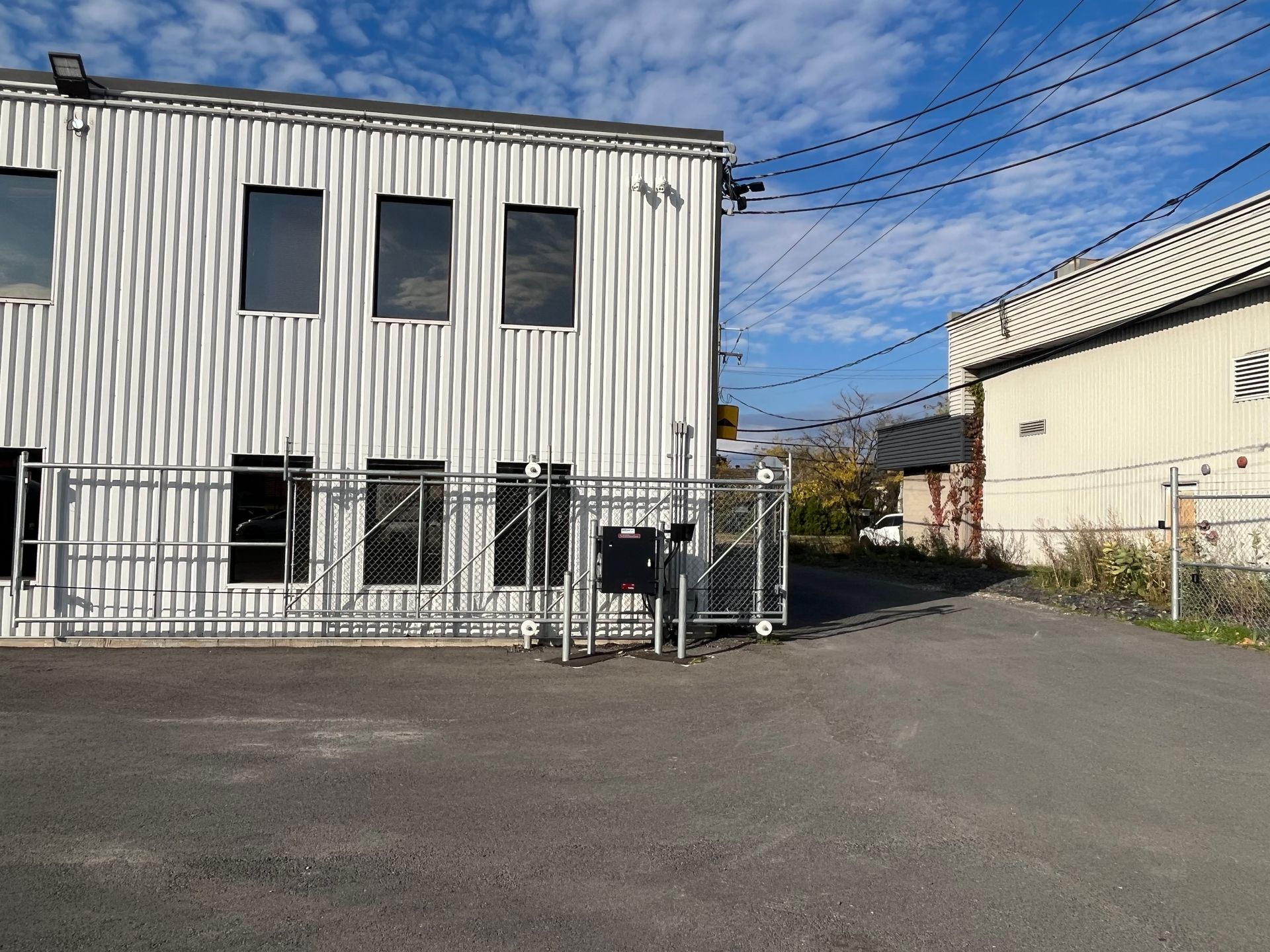 Un grand bâtiment blanc entouré d'une clôture