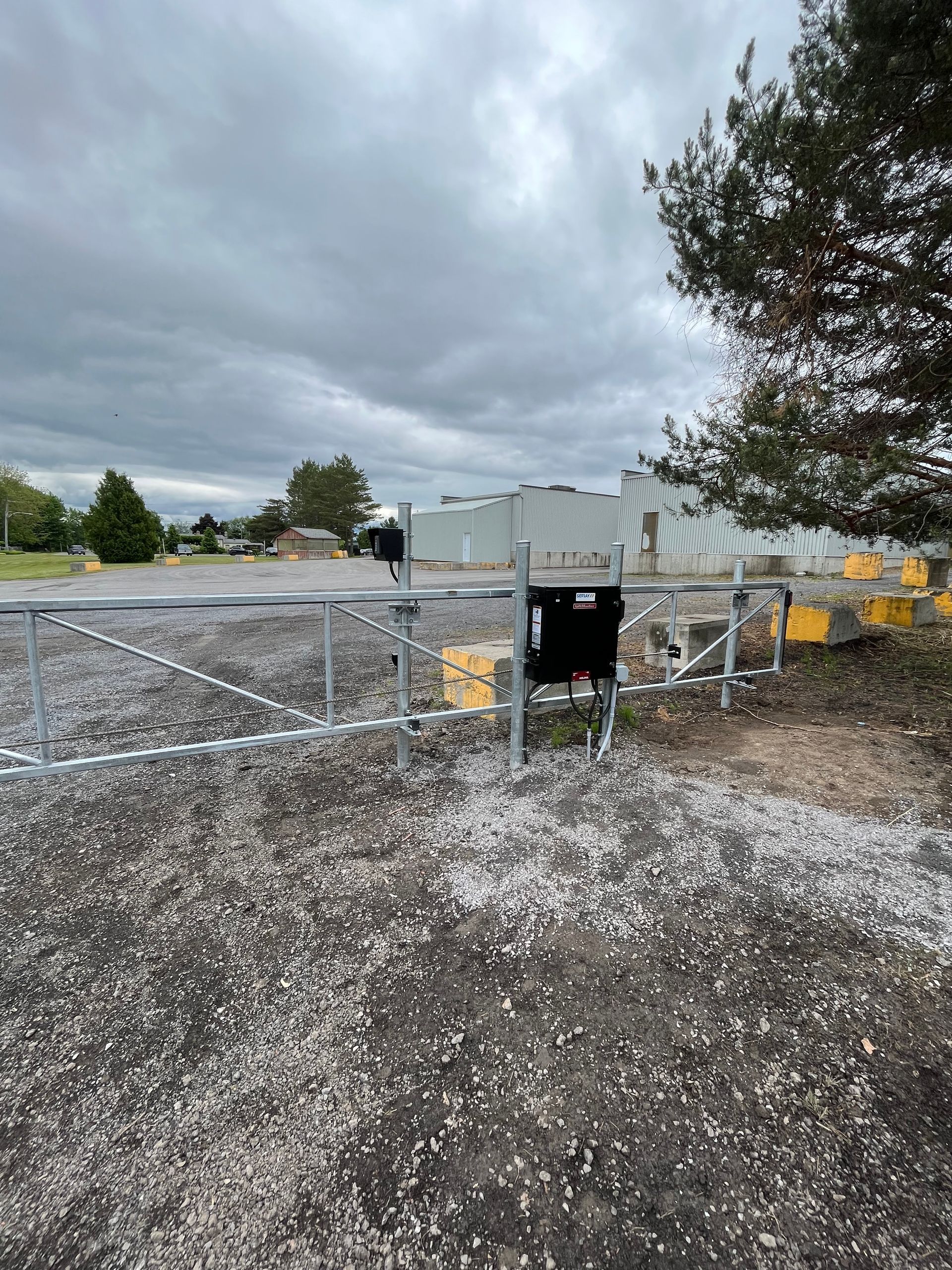 Une porte en métal se trouve au milieu d'un champ de gravier.